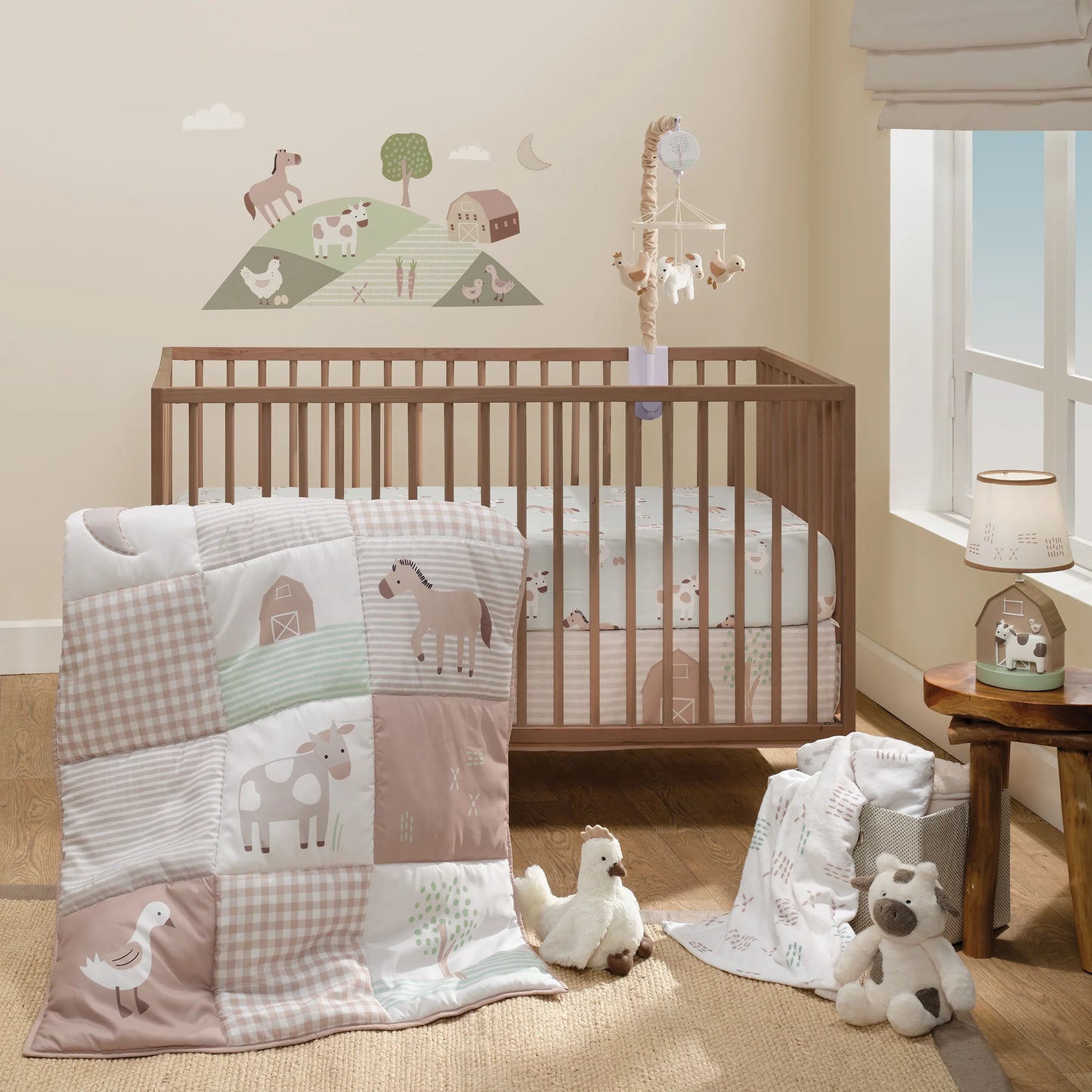 Nursery room with wooden crib and baby bedding featuring animal patterns.