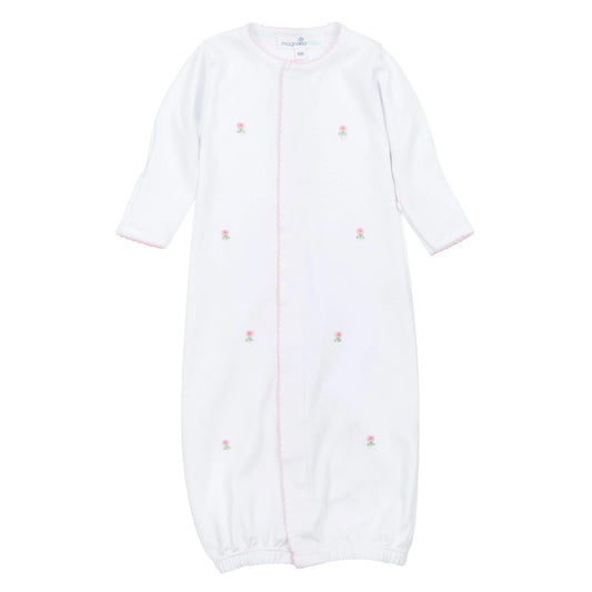 White baby onesie with pink floral patterns on a white background
